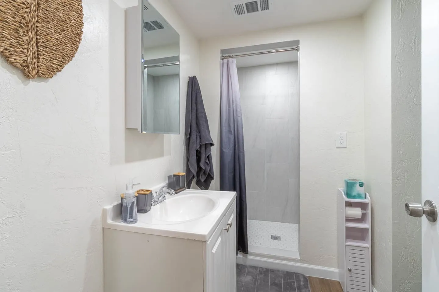 Unit 4 bathroom with a vanity, mirror and shower