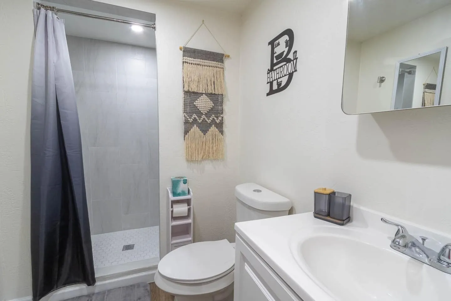 Unit 3 bathroom with a walk-in shower, vanity and toilet