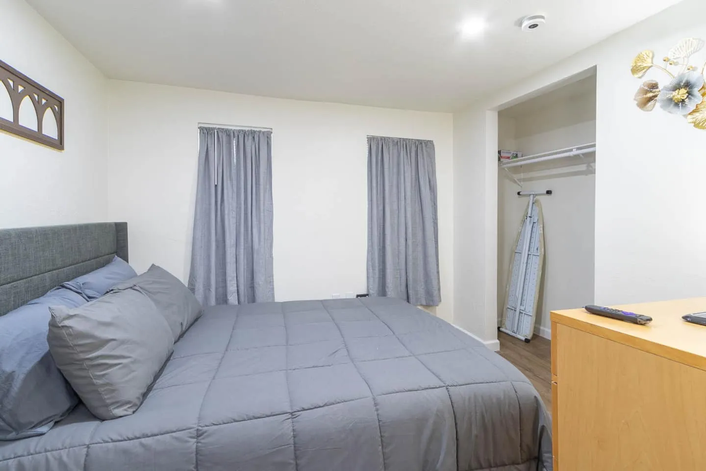 Unit 3 bedroom with gray bedding, a closet and a dresser