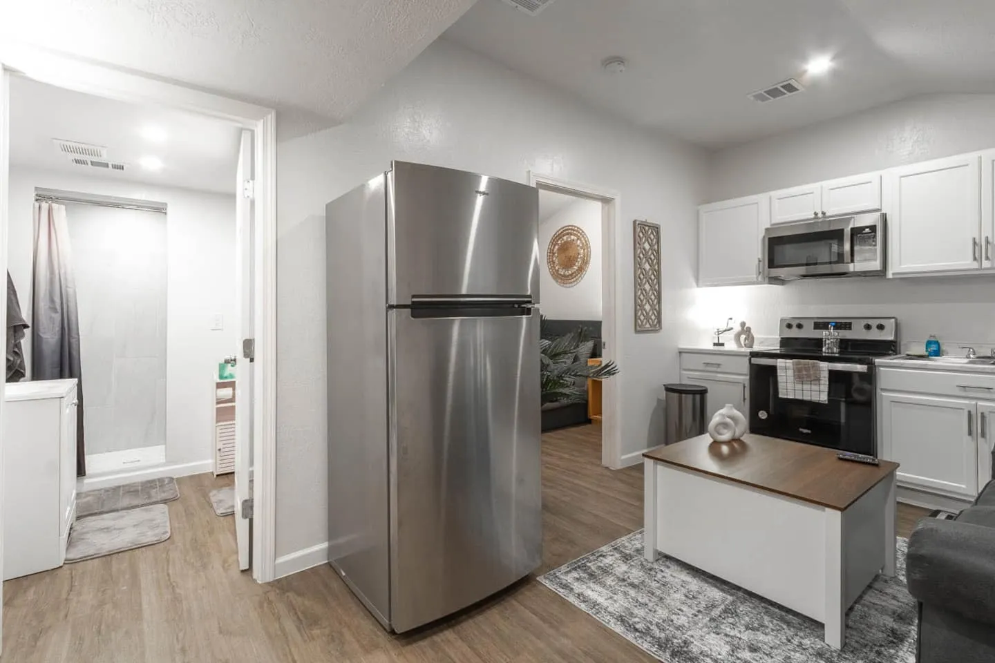 Unit 4 living room and kitchenette with a stainless steel refrigerator